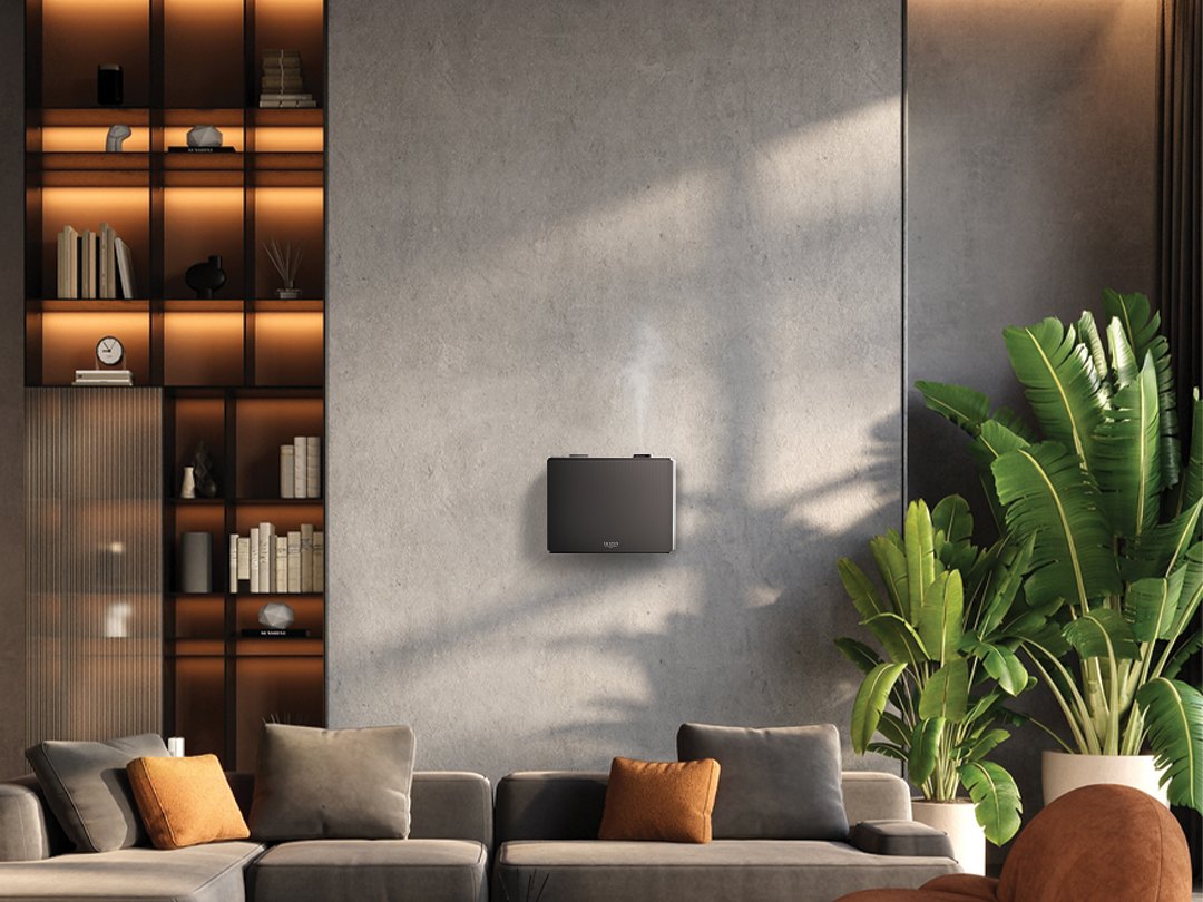 Wall-mounted Shizen SBV1 in a modern lounge with plants and a sofa